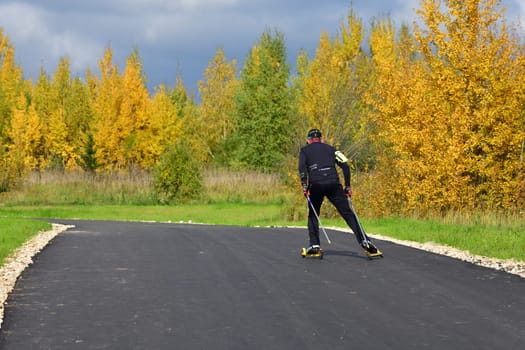 Moscow, Russia - 29 Sept. 2021. man on roller skis rides along a sports track in Zelenograd