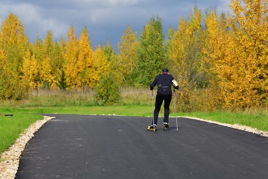 Moscow, Russia - 29 Sept. 2021. man on roller skis rides along a sports track in Zelenograd