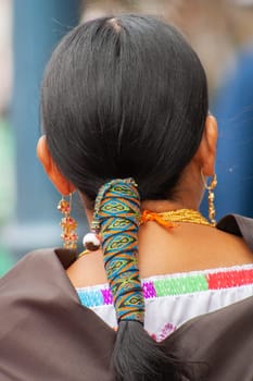 indigenous woman's ponytail from behind and part of her traditional dress. High quality photo