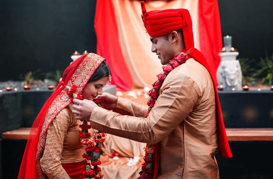 Wedding, marriage and flowers with a couple together in celebration of love at a ceremony. Happy, romance or islamic with a hindi bride and groom getting married outdoor in tradition of their culture.