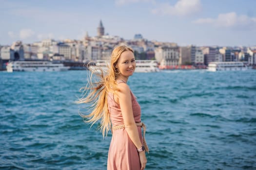 Portrait of beautiful woman tourist with view of Galata tower in Beyoglu, Istanbul, Turkey. Turkiye.