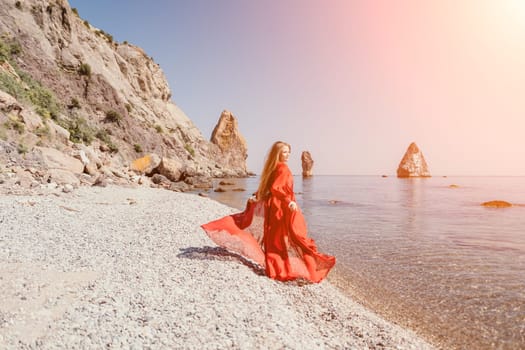 Woman travel sea. Happy tourist taking picture outdoors for memories. Woman traveler looks at the edge of the cliff on the sea bay of mountains, sharing travel adventure journey.