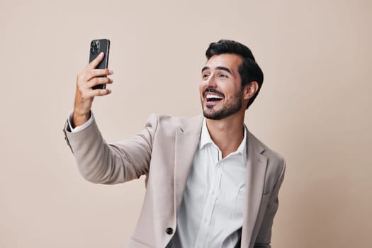man gray app entrepreneur suit business internet smile portrait handsome smartphone happy cellphone cell hold call beige technology isolated corporate phone