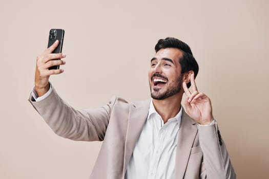 hold man happy message handsome lifestyle suit smile studio portrait phone selfies space beard smartphone confident call success young white copy business