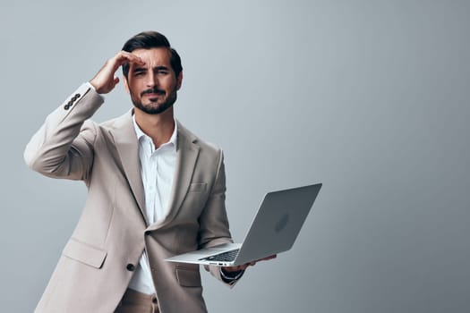 man smile business stylish notebook working laptop cheerful freelancer copyspace job manager computer internet suit smiling entrepreneur handsome portrait studio beard