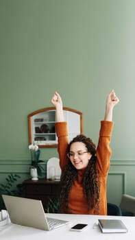 Young excited happy woman student winner success using computer laptop winning online at home, celebrating great exam results or new job opportunity receiving email with approval concept