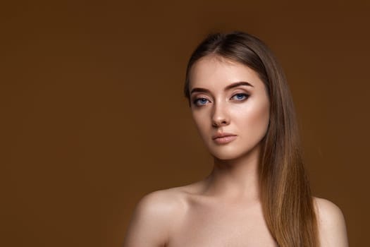portrait of beautiful young woman with perfect skin on beige background. copy space