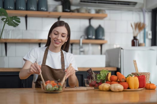 Young woman cooking in the kitchen. Healthy food vegetable salad. Diet. dieting concept. Healthy lifestyle. Cooking at home. Prepare food.