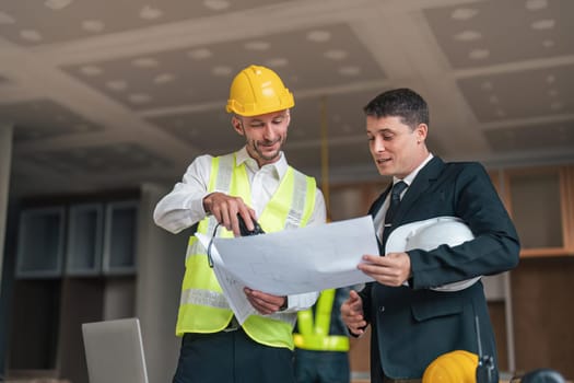 Professional construction engineers team using blueprint of project plan brainstorming and working together at construction building, Architecture and building construction concept.