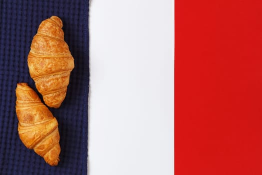 Delicious croissants on textiles in the form of the flag of France. copy space.