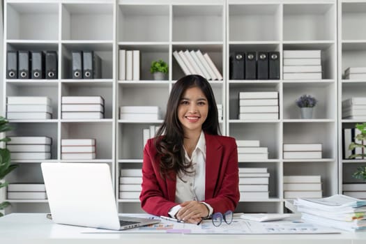 Happy business lady smiling to camera posing working sitting at workplace in office.