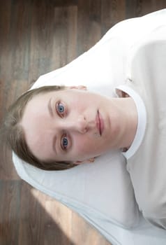 Portrait Of Caucasian Young Woman After Eyelash Lamination Procedure, Lash Treatment Lying on Couch. Top View. Vertical Plane High quality photo.