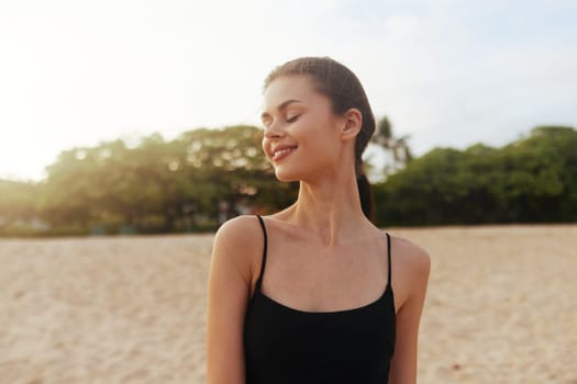 ocean woman smile sand vacation beach lifestyle outdoor happy young sky travel sea smiling sunset copy-space nature beauty freedom shore summer