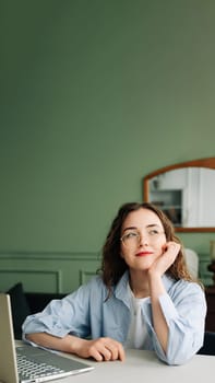 Serious Businesswoman Pondering Question or Idea on Laptop, Feeling Doubt While Working or Learning at Home or Office.