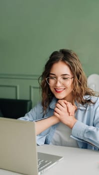 Excited young business woman celebrating success reading laptop screen, receiving good news email with salary growth opportunity.