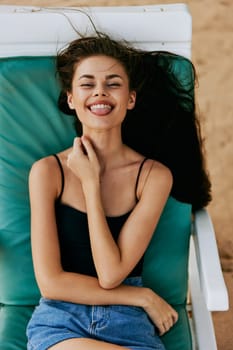 woman smiling sand relaxation young resort travel water holiday tan girl beautiful blue tropical caucasian sunbed sea ocean lifestyle lying beach