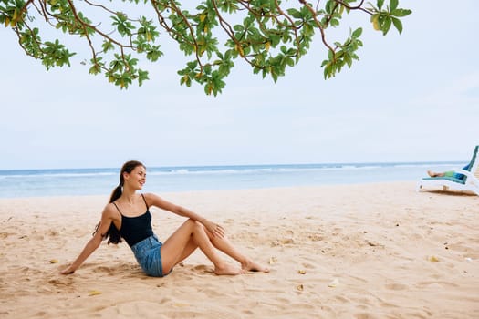 lifestyle woman sitting caucasian smile beach nature travel model vacation holiday sand back bali female sea view person sexy beauty freedom beautiful