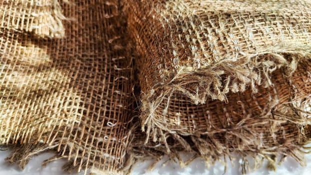 Natural fabric texture, frame and background of burlap. Rough crumpled burlap background. Selective focus