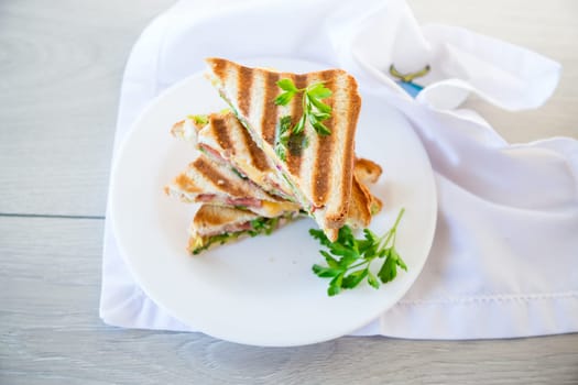 fried toasts stuffed with sausage, cheese and greens inside, in a bowl on the table..