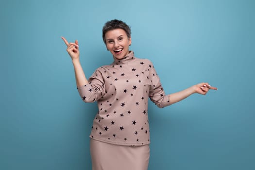 surprised puzzled young gray-haired european woman dressed in a blouse and skirt shows with her hands at an advertising offer.