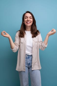 optimistic brunette young brunette lady dressed in shirt and jeans.