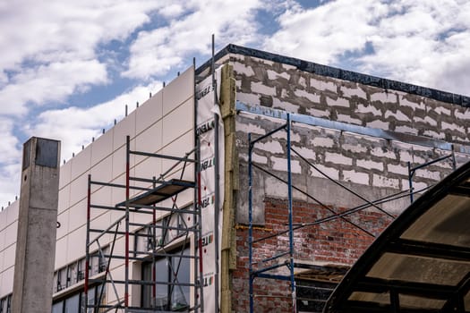 exterior walls of the building for cladding facades with decorative panels. crate on the facade of the building. Building house, installation of galvanized crate