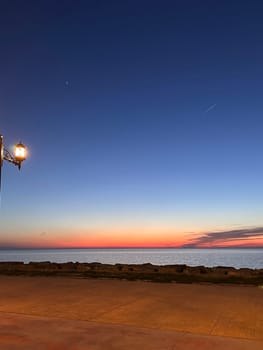 Orange glow on the sea horizon after sunset, mobile photo. High quality photo