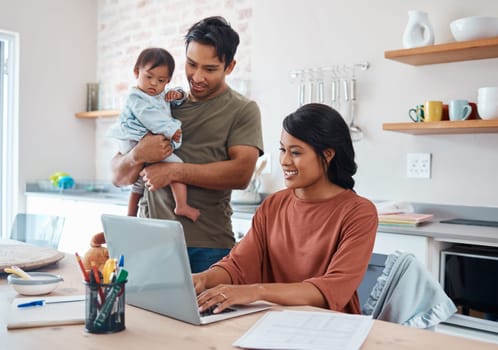 Internet, family and parents doing research on down syndrome with baby on a laptop in their house. Mother and father with smile for child and working on taxes or finance budget on the computer.