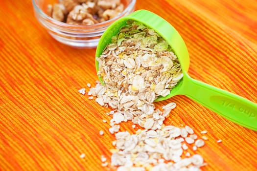 oatmeal in a volumetric spoon on a napkin Orange.