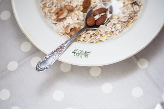 Oatmeal in bowl with nuts, useful food