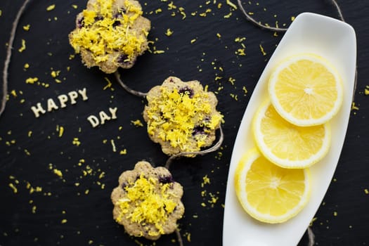 lemon cupcakes on a black background - inscription happy day