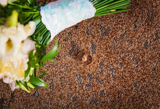 ring and beautiful bouquet of different flowers on a chair