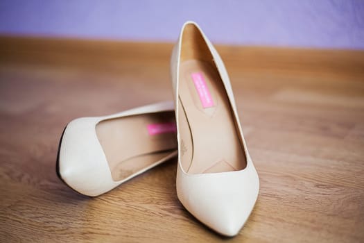 beautiful wedding shoes are on the floor.