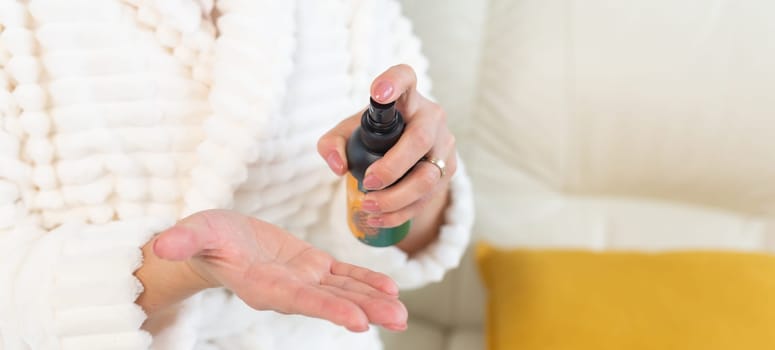 Cosmetics foam pump container and facewash dispenser in a woman hand.