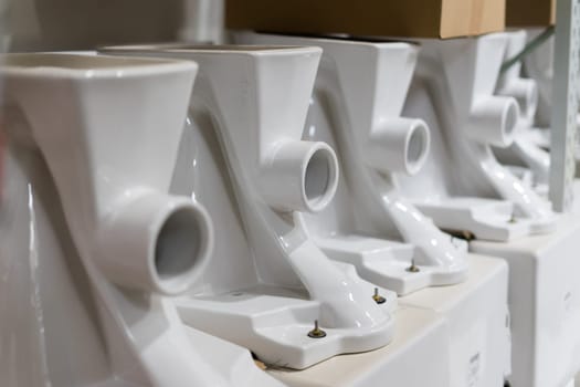 Lot of white toilets in a hardware store, plumbing department