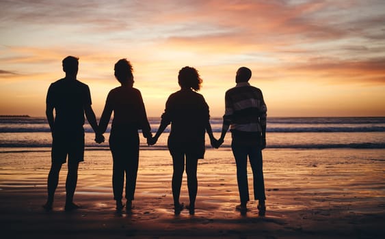 Silhouette, friends and beach sunset holding hands in freedom, support and calm peace in nature together. Back shadow fun couples group relax, summer ocean horizon and tropical vacation in solidarity.