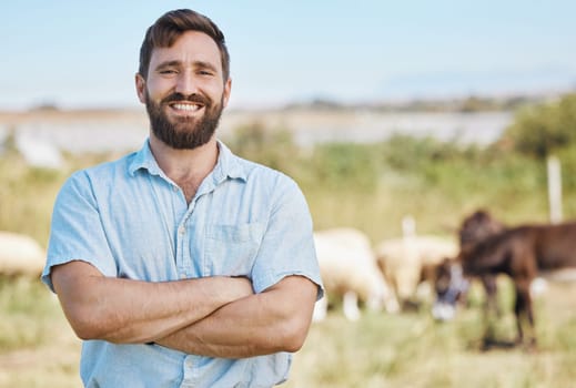 Farmer, portrait or arms crossed on livestock agriculture, sustainability environment or nature for farming industry. Smile, happy or confident man with animals growth or sheep and person on a field.