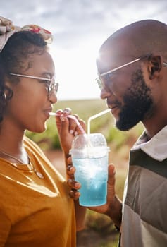 Couple, drink and date with a black woman and man drinking a beverage while outdoor in nature during summer. Dating, romance and together with a boyfriend and girlfriend using a straw closeup.