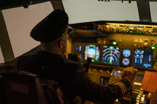 A man is studying to be a pilot in an aircraft simulator