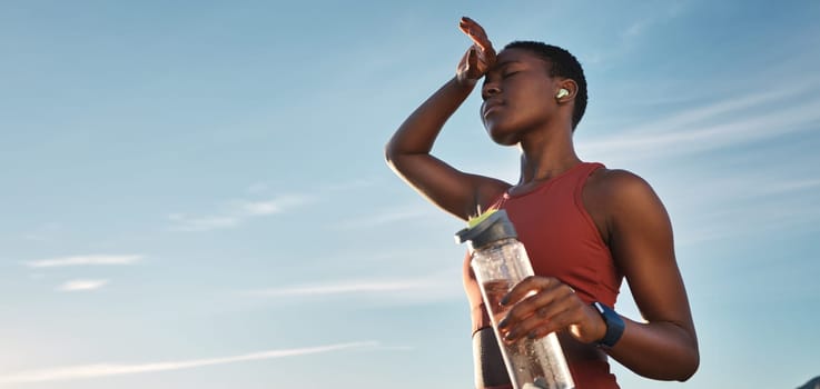 Water bottle, tired and black woman on break after running, exercise or cardio workout with low angle and mock up. Sports, fitness and sweating female holding liquid for hydration after training