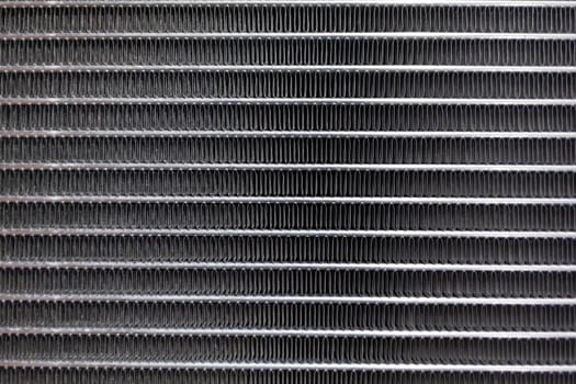 Texture of a car radiator. Engine cooler background. Vintage style. Radiator grille for car interior heater air conditioner, close-up. Radiator repair and replacement.