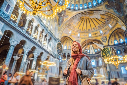 INSCRIPTION - denoting the names of Allah, the Prophet Muhammad, as well as the first 4 caliphs Woman tourist enjoying Hagia Sofia, Ayasofya interior in Istanbul, Turkey, Byzantine architecture, city landmark and architectural world wonder. Turkiye.