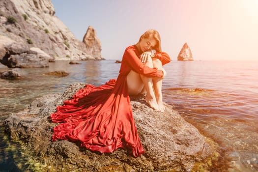 Woman travel sea. Happy tourist taking picture outdoors for memories. Woman traveler looks at the edge of the cliff on the sea bay of mountains, sharing travel adventure journey.