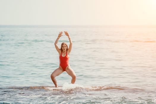 Woman sea yoga. Back view of free calm happy satisfied woman with long hair standing on top rock with yoga position against of sky by the sea. Healthy lifestyle outdoors in nature, fitness concept.