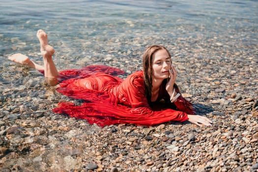 Woman travel sea. Happy tourist taking picture outdoors for memories. Woman traveler looks at the edge of the cliff on the sea bay of mountains, sharing travel adventure journey.