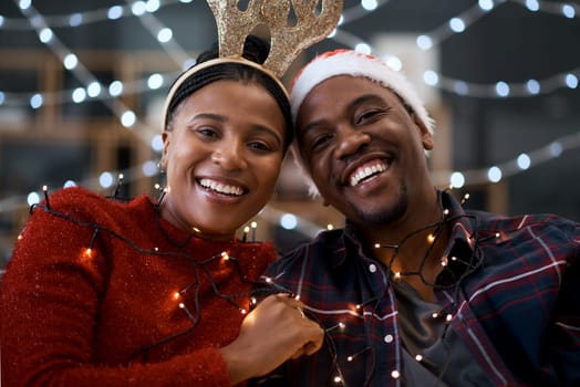 Black couple, Christmas and portrait smile for happy relationship bonding during festive season in the outdoors. Man and woman hug, smiling and enjoying quality time in celebration with city lights.