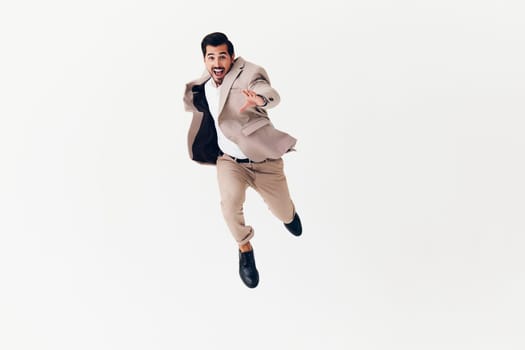 beard man confident winner businessman running happy beige flying arm young isolated smiling model background suit professional business studio smile victory