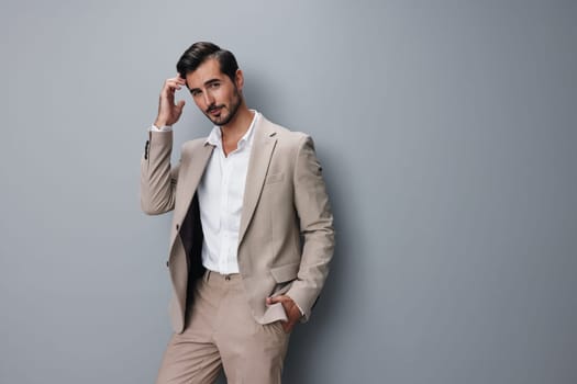 man office suit beige isolated smiling handsome occupation formal guy person job model businessman posing copyspace business arm portrait smile happy