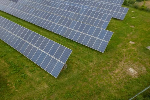 Renewable energy. Aerial shot drones fly over a photovoltaic power station. Group pf solar panels looking the sun for energy production.