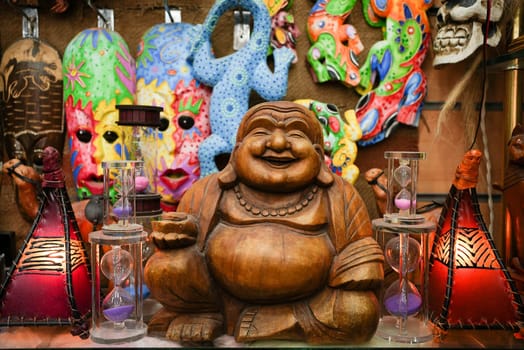 Small Buddha and other colourful Buddhism spiritual symbols at a store . High quality photo